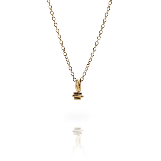 Small gold textured charm on a fine gold chain on a white background.